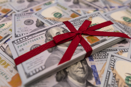 wad of cash wrapped up in a bow
